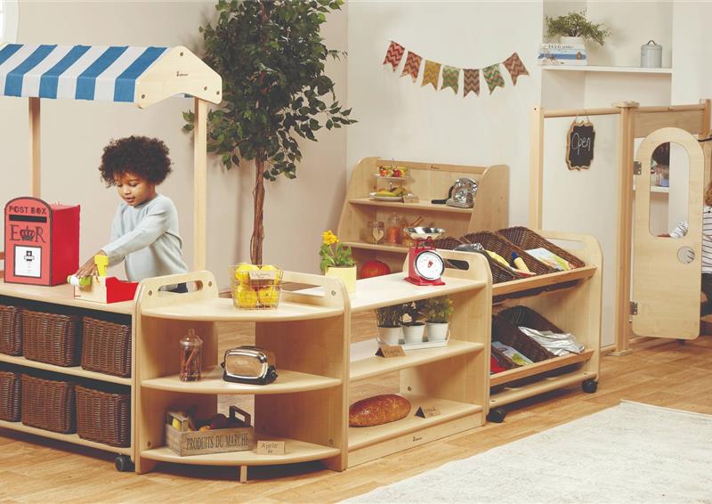 Two boys are playing shops inside the Role Play Zone inside a classroom